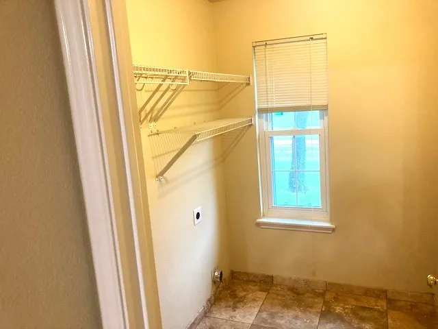a bathroom with a window and a shower