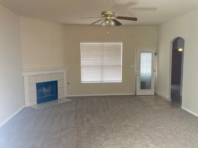 a view of empty room with a fireplace