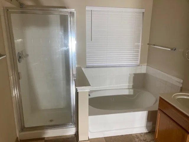 a bathroom with a shower and a sink