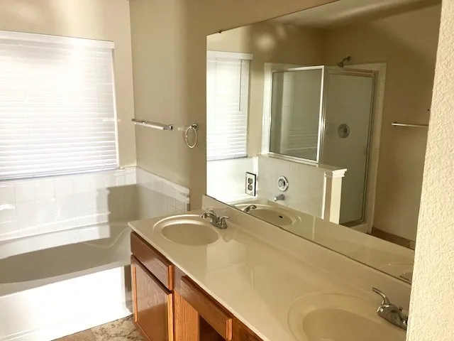 a bathroom with a granite countertop sink and a large mirror
