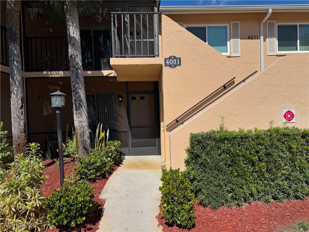 a front view of a house with plants