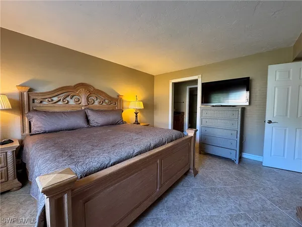 a bedroom with a bed and a television