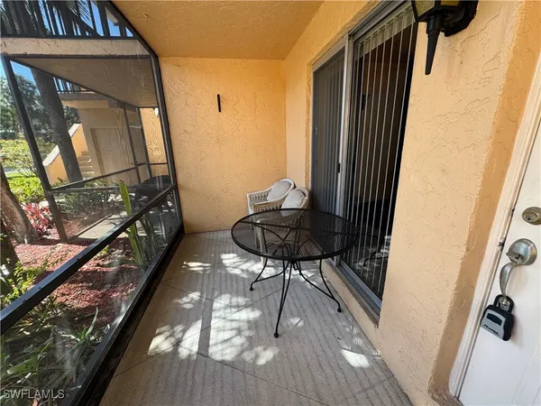 a view of a hallway with wooden floor and furniture