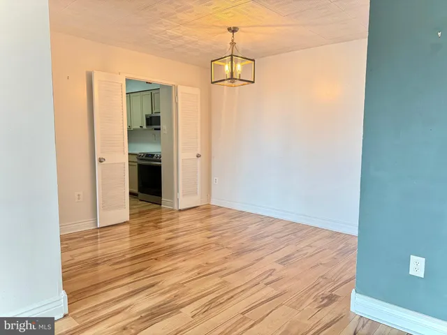 a view of a room with wooden floor and natural light
