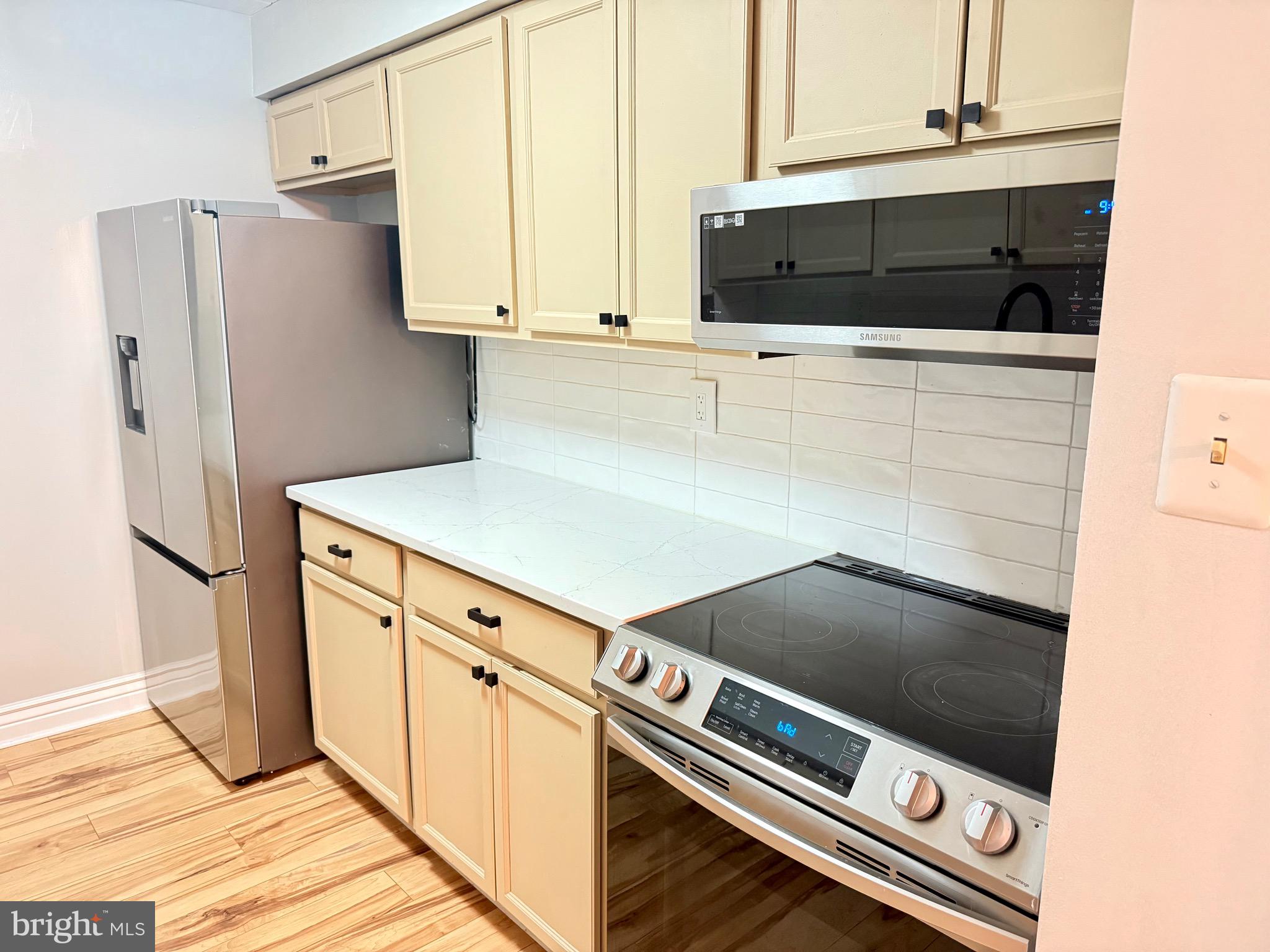 5300 Holmes Run Parkway, Unit 1012 Alexandria, VA 22304 - Photo 7 of 12 a kitchen with stainless steel appliances a refrigerator and a stove