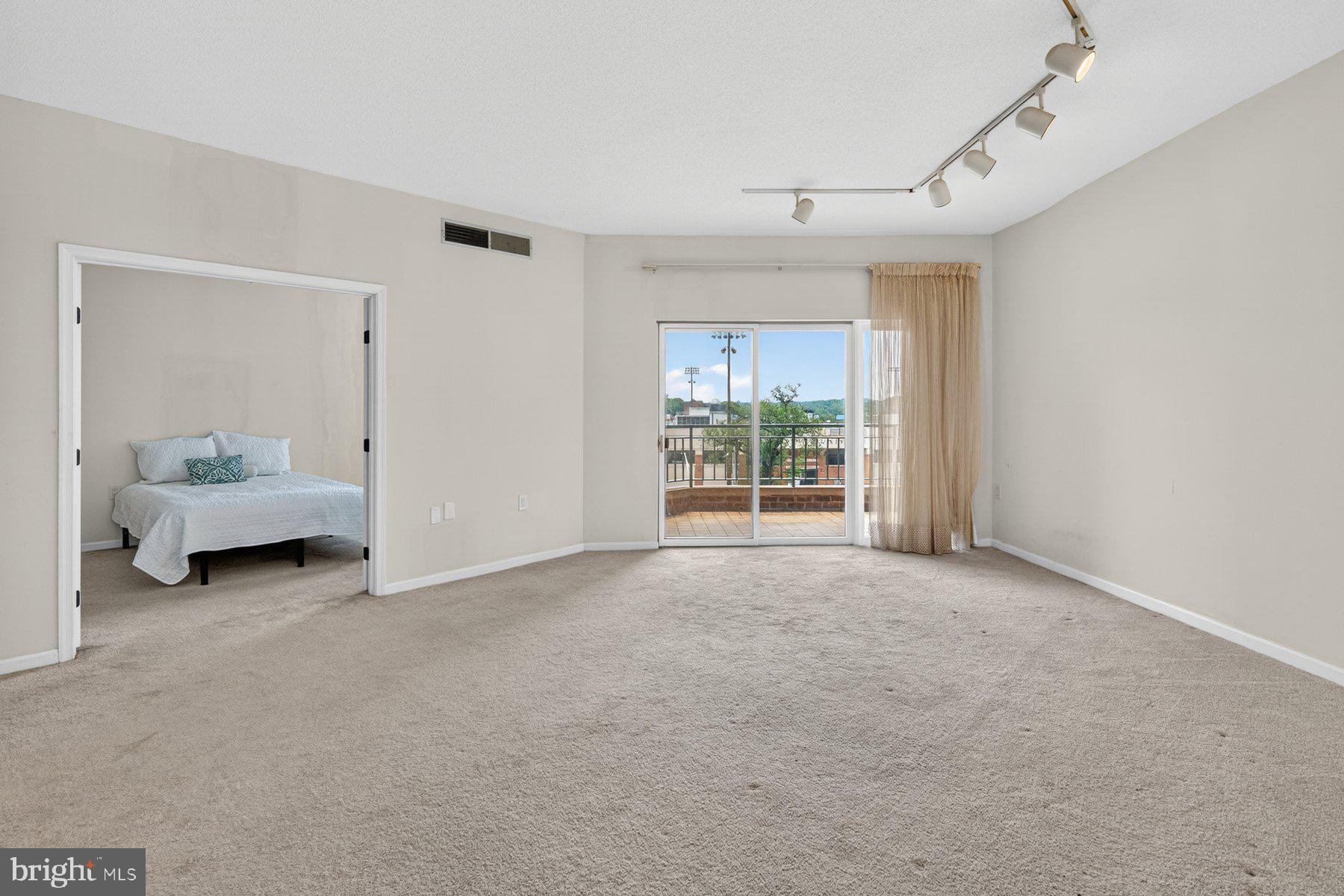 3801 Canterbury Road, Unit 403 Baltimore, MD 21218 - Photo 9 of 25 Spacious room with natural light.