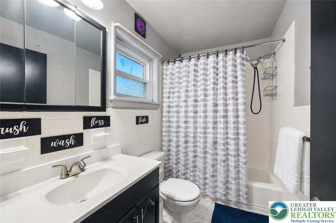 2649 Nottingham Road Bethlehem, PA 18017 - Photo 19 of 49 A well-appointed bath features a combined shower and tub, sleek vanity, and bright window for natural illumination.