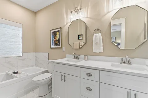 a bathroom with a toilet a sink and mirror