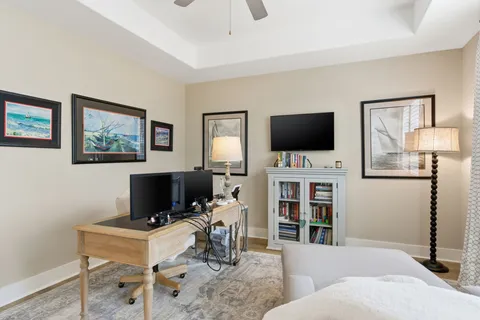 a living room with furniture a flat screen tv and a window