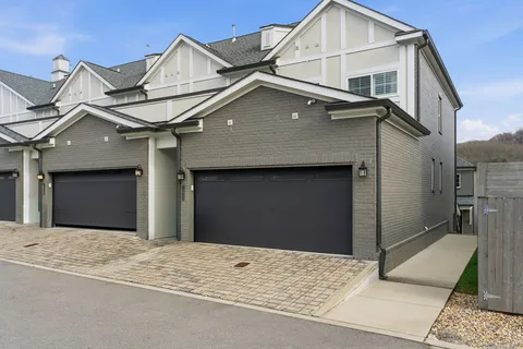 an aerial view of a house with a mountain