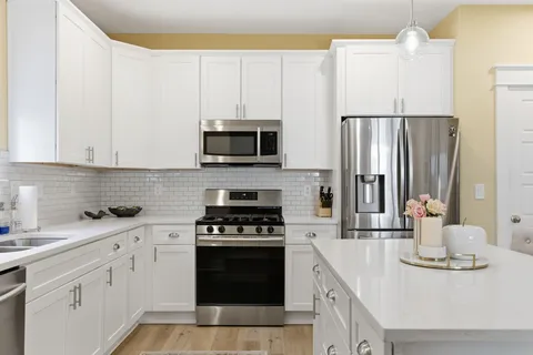 a kitchen with cabinets a sink and appliances
