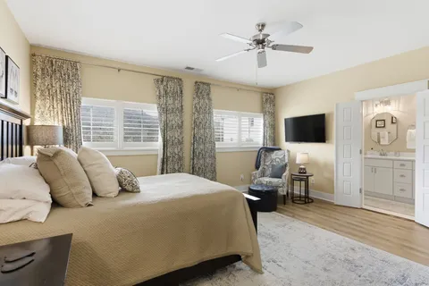 a bedroom with a large bed and a flat screen tv