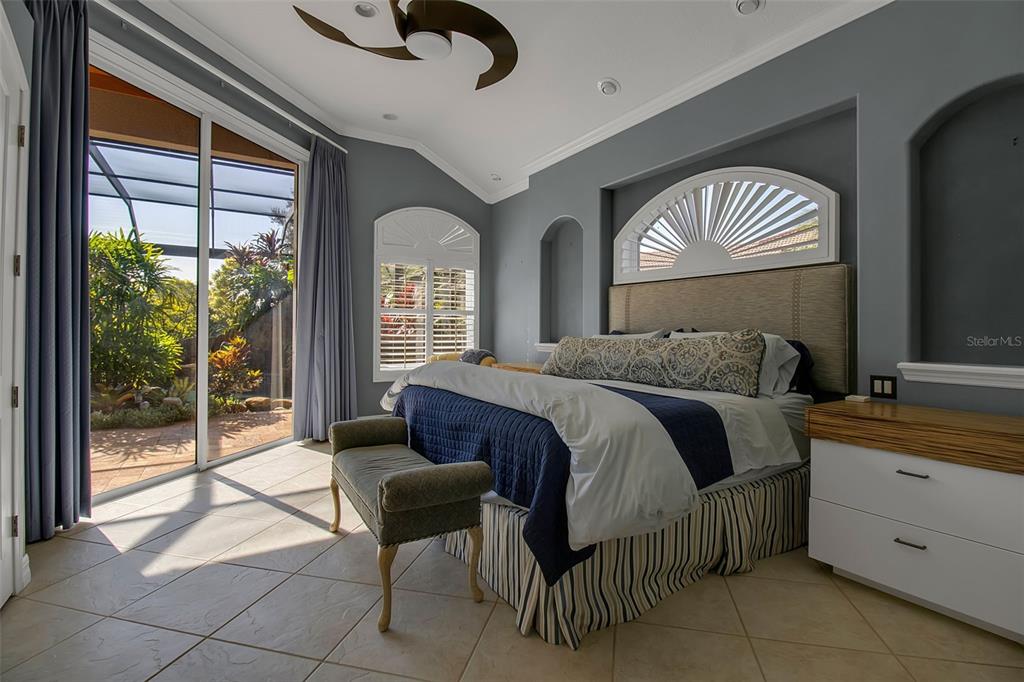 8116 Lone Tree Glen Lakewood Ranch, FL 34202 - Photo 18 of 48 a spacious bedroom with a bed and a dresser next to a window