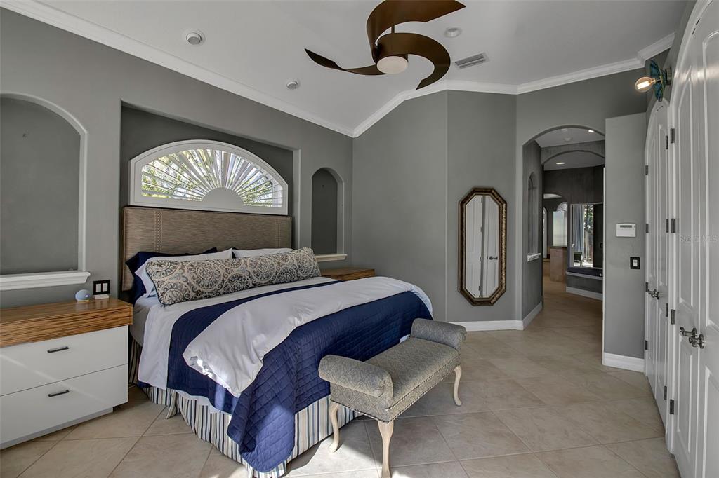 8116 Lone Tree Glen Lakewood Ranch, FL 34202 - Photo 19 of 48 a bedroom with a bed and a painting on the wall