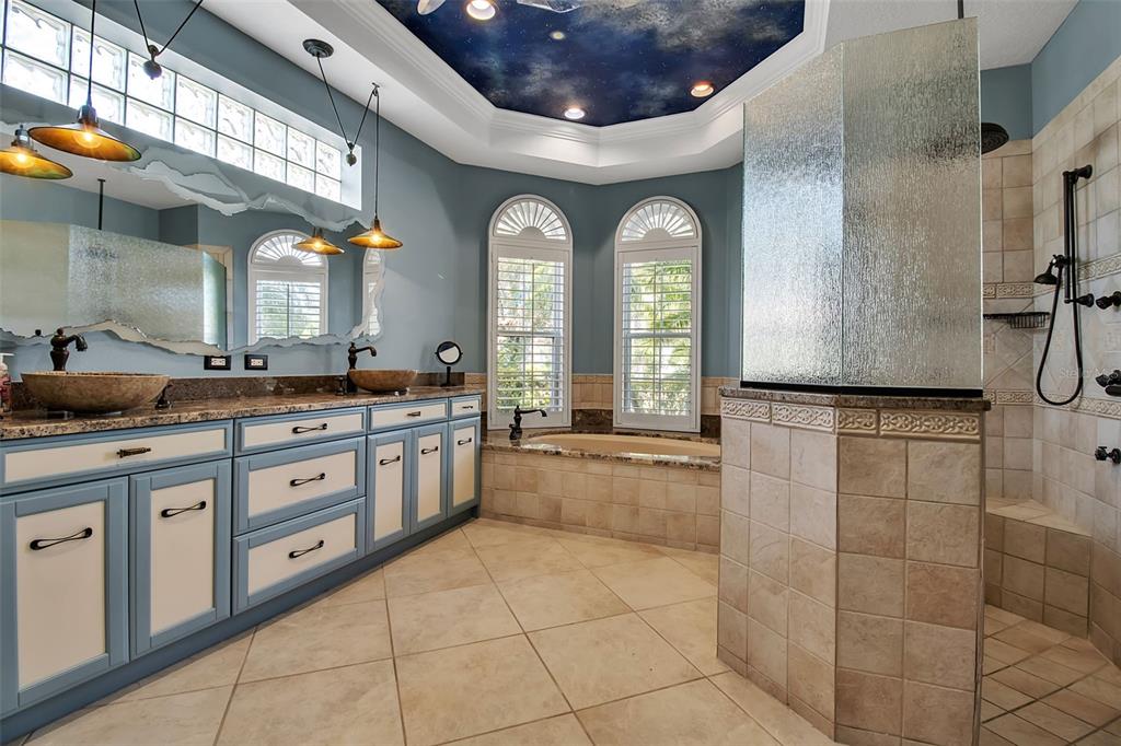 8116 Lone Tree Glen Lakewood Ranch, FL 34202 - Photo 20 of 48 a large bathroom with a granite countertop sink a mirror and a bathtub