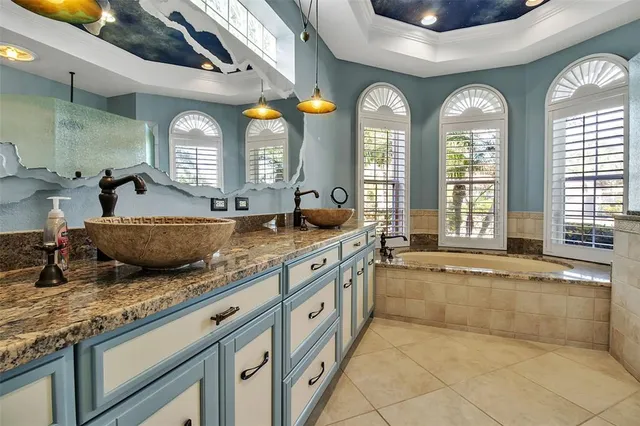 a bathroom with a granite countertop sink a toilet and shower