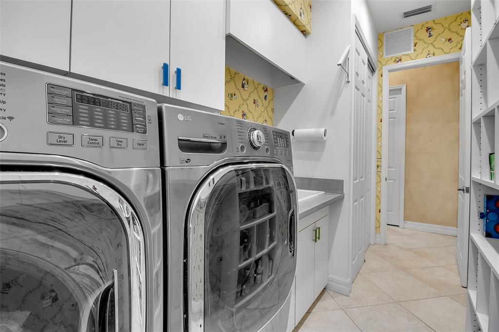 8116 Lone Tree Glen Lakewood Ranch, FL 34202 - Photo 40 of 48 a view of walk in closet with washer and dryer