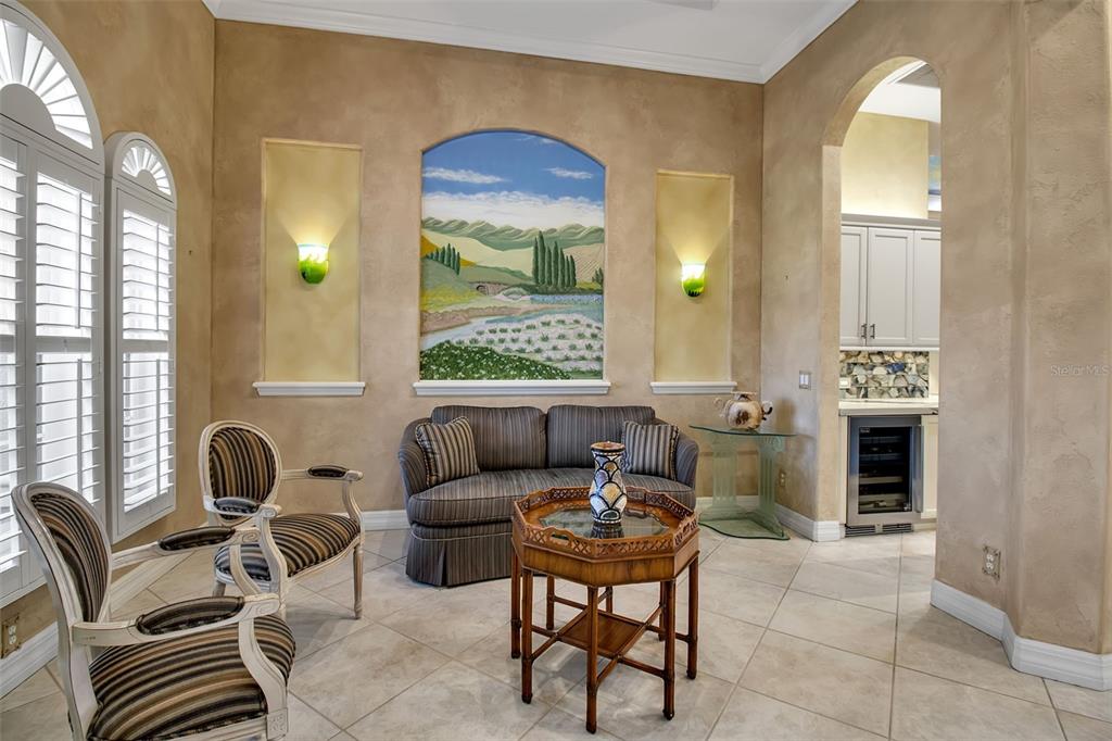 8116 Lone Tree Glen Lakewood Ranch, FL 34202 - Photo 7 of 48 a living room with furniture a fireplace and a large window