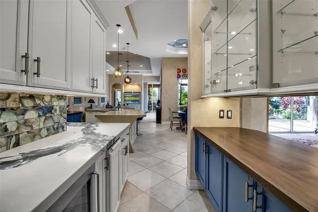 a kitchen with a stove sink and cabinets
