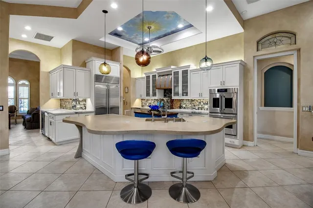 a spacious bedroom with a bed and a dresser next to a window