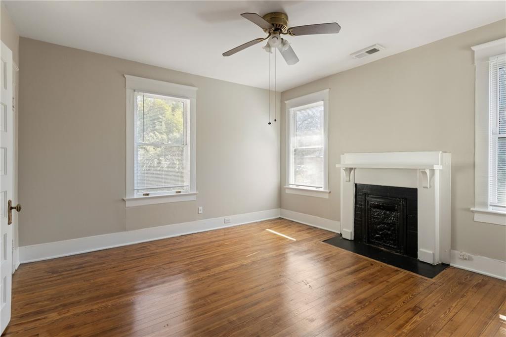120 South Candler Street Decatur, GA 30030 - Photo 31 of 40 a view of an empty room with wooden floor fireplace and a window