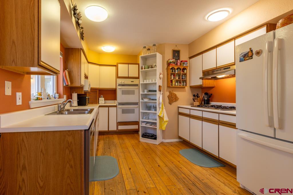 171 Deer Trail Road Durango, CO 81303 - Photo 11 of 35 a kitchen with stainless steel appliances a stove and a refrigerator