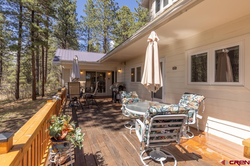 171 Deer Trail Road Durango, CO 81303 - Photo 13 of 35 a view of a patio with table and chairs with wooden floor and fence
