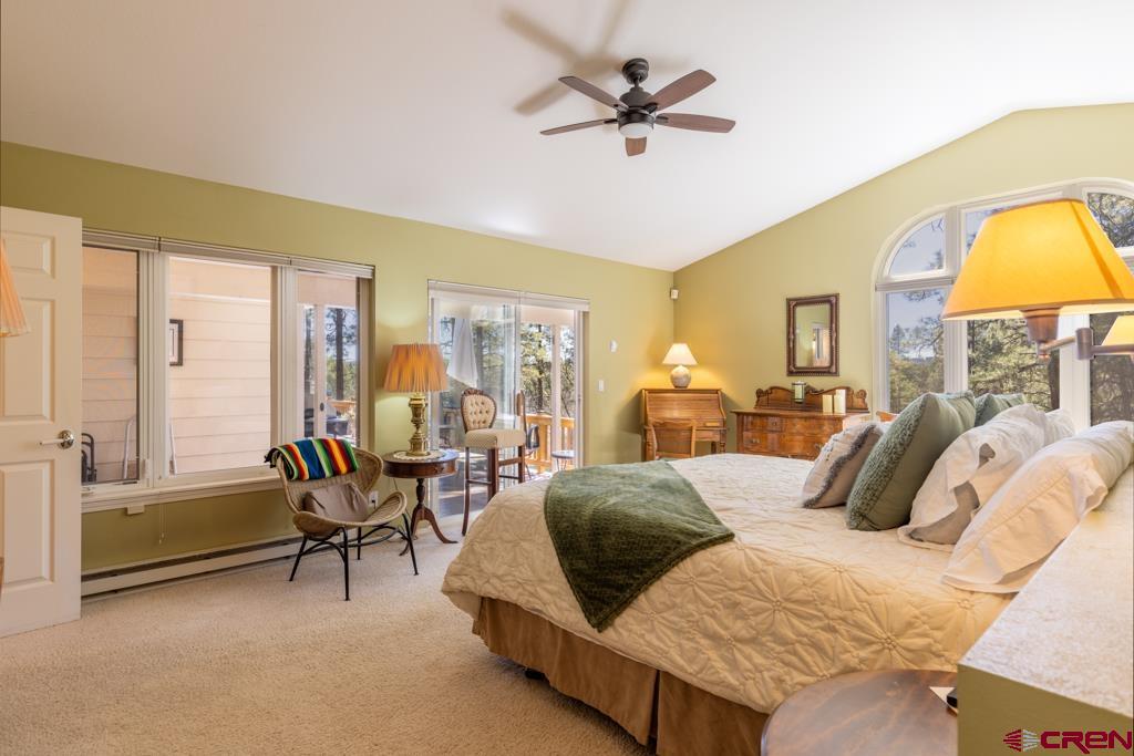 171 Deer Trail Road Durango, CO 81303 - Photo 14 of 35 a bedroom with a bed and large windows