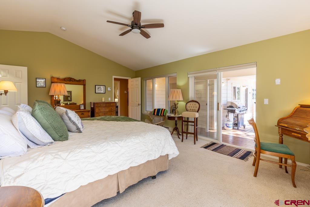 171 Deer Trail Road Durango, CO 81303 - Photo 16 of 35 a bed room with a bed and a chair