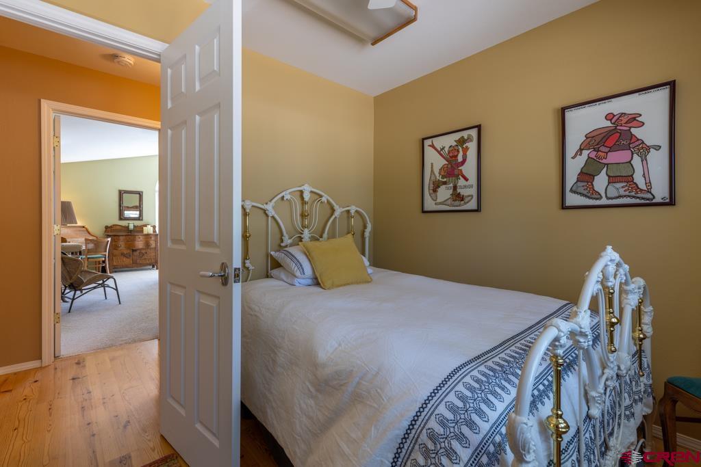 171 Deer Trail Road Durango, CO 81303 - Photo 19 of 35 a bedroom with a bed and a painting on the wall