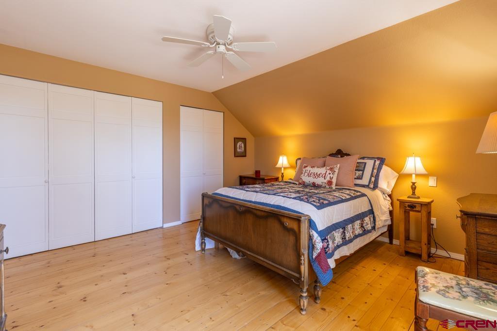 171 Deer Trail Road Durango, CO 81303 - Photo 21 of 35 a bed sitting in a spacious bedroom next to a lamp