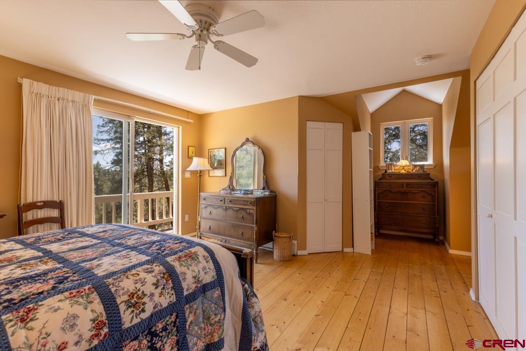 171 Deer Trail Road Durango, CO 81303 - Photo 22 of 35 a bedroom with a bed and a dresser