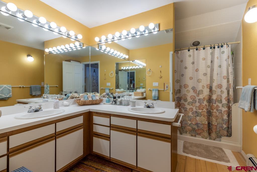 171 Deer Trail Road Durango, CO 81303 - Photo 23 of 35 a bathroom with a double vanity sink mirror and shower