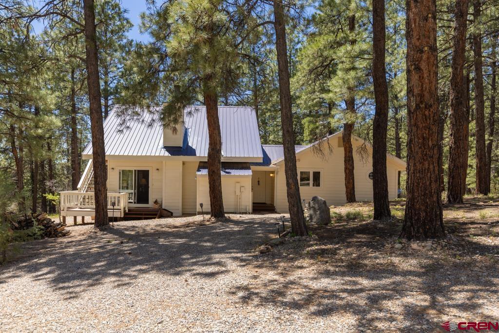 171 Deer Trail Road Durango, CO 81303 - Photo 3 of 35 a front view of a house with a tree
