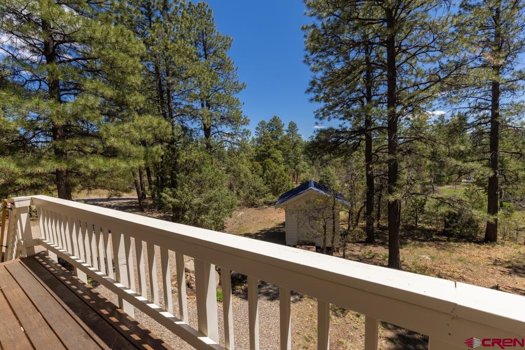 171 Deer Trail Road Durango, CO 81303 - Photo 33 of 35 a view of a wooden balcony and trees