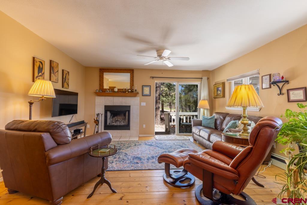 171 Deer Trail Road Durango, CO 81303 - Photo 7 of 35 a living room with furniture fireplace and a large window