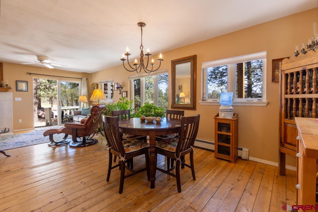 171 Deer Trail Road Durango, CO 81303 - Photo 9 of 35 a view of a dining room with furniture window and wooden floor