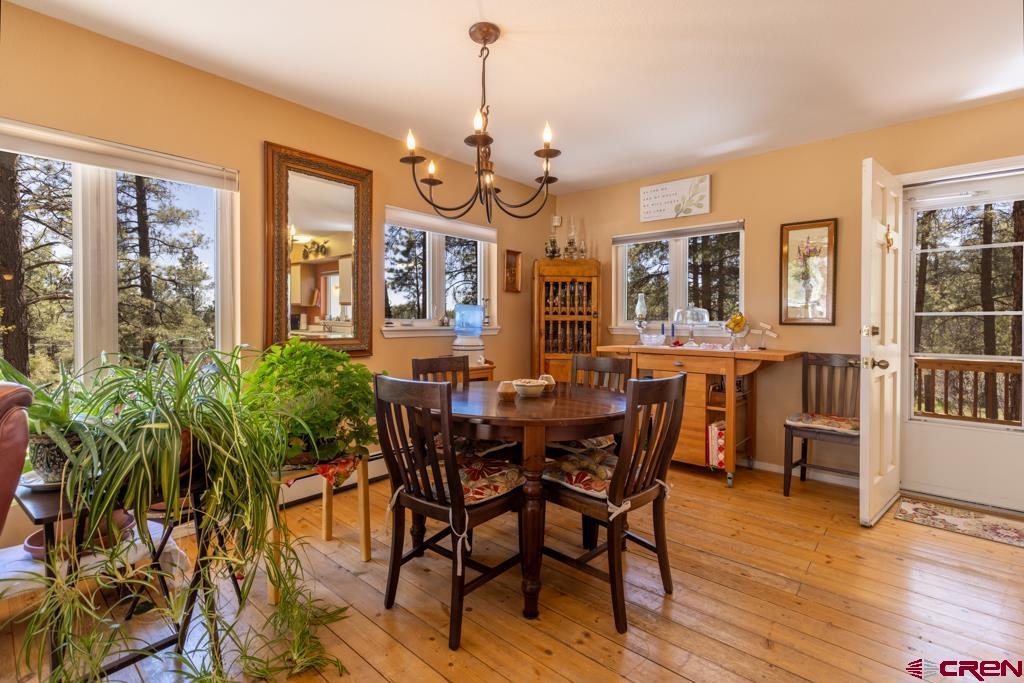 171 Deer Trail Road Durango, CO 81303 - Photo 10 of 35 a view of a dining room with furniture window and wooden floor