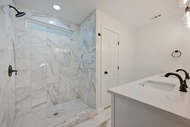 a bathroom with a shower and sink