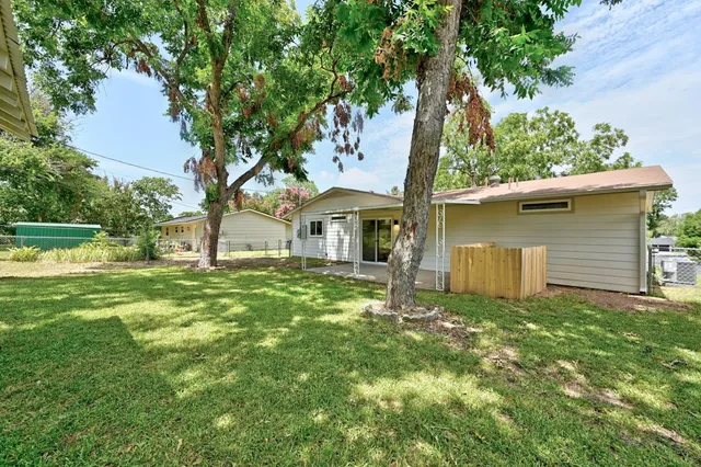 a view of a house with a yard and sitting area