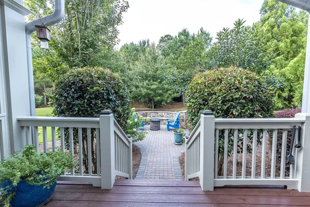 a view of a hallway with wooden floor and workspace