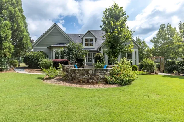 a living room with fireplace furniture and a chandelier