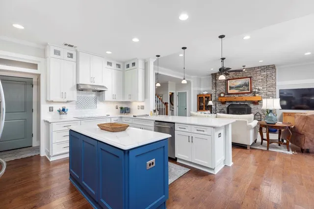 a spacious bedroom with a bed and a chandelier