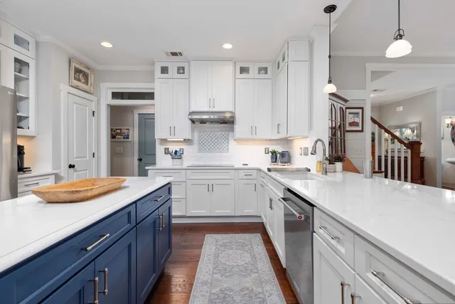 a spacious bathroom with a granite countertop double vanity sink and mirror