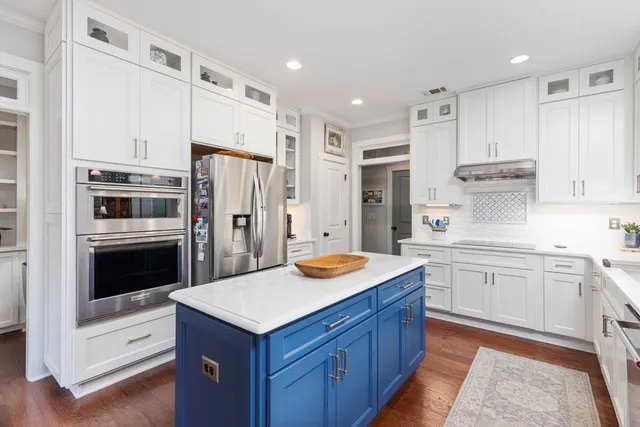 a bathroom with a double vanity sink a toilet and shower