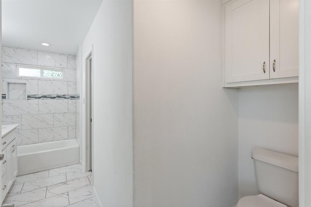 810 South Main Street Kemp, TX 75143 - Photo 12 of 16 a bathroom with a shower and a toilet