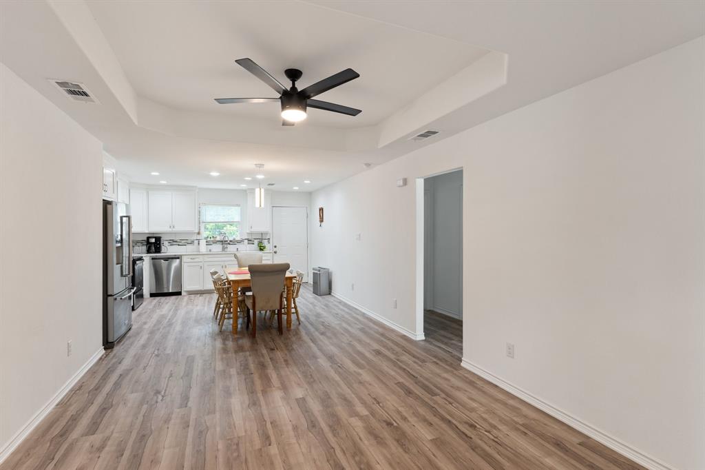 810 South Main Street Kemp, TX 75143 - Photo 3 of 16 a view of a dining room with furniture and wooden floor