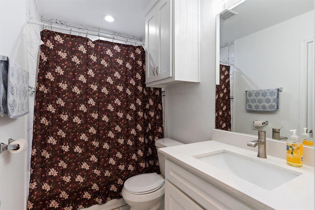 810 South Main Street Kemp, TX 75143 - Photo 9 of 16 a bathroom with a sink a toilet and a mirror