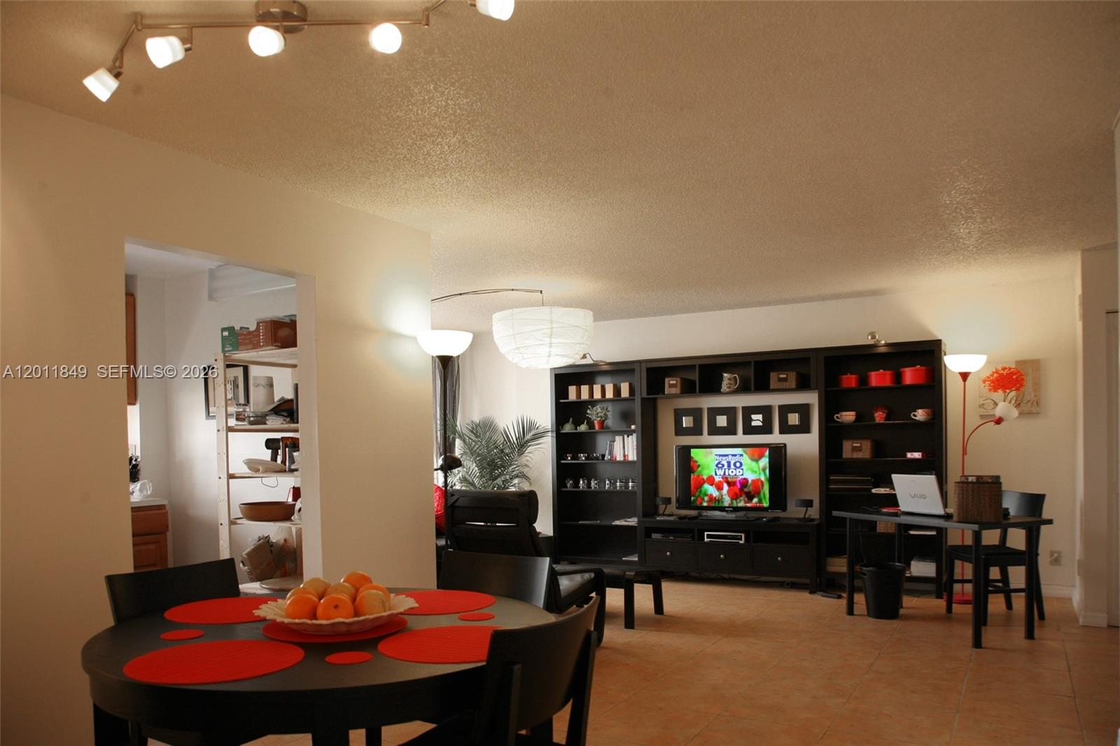 a living room with furniture a rug and a flat screen tv