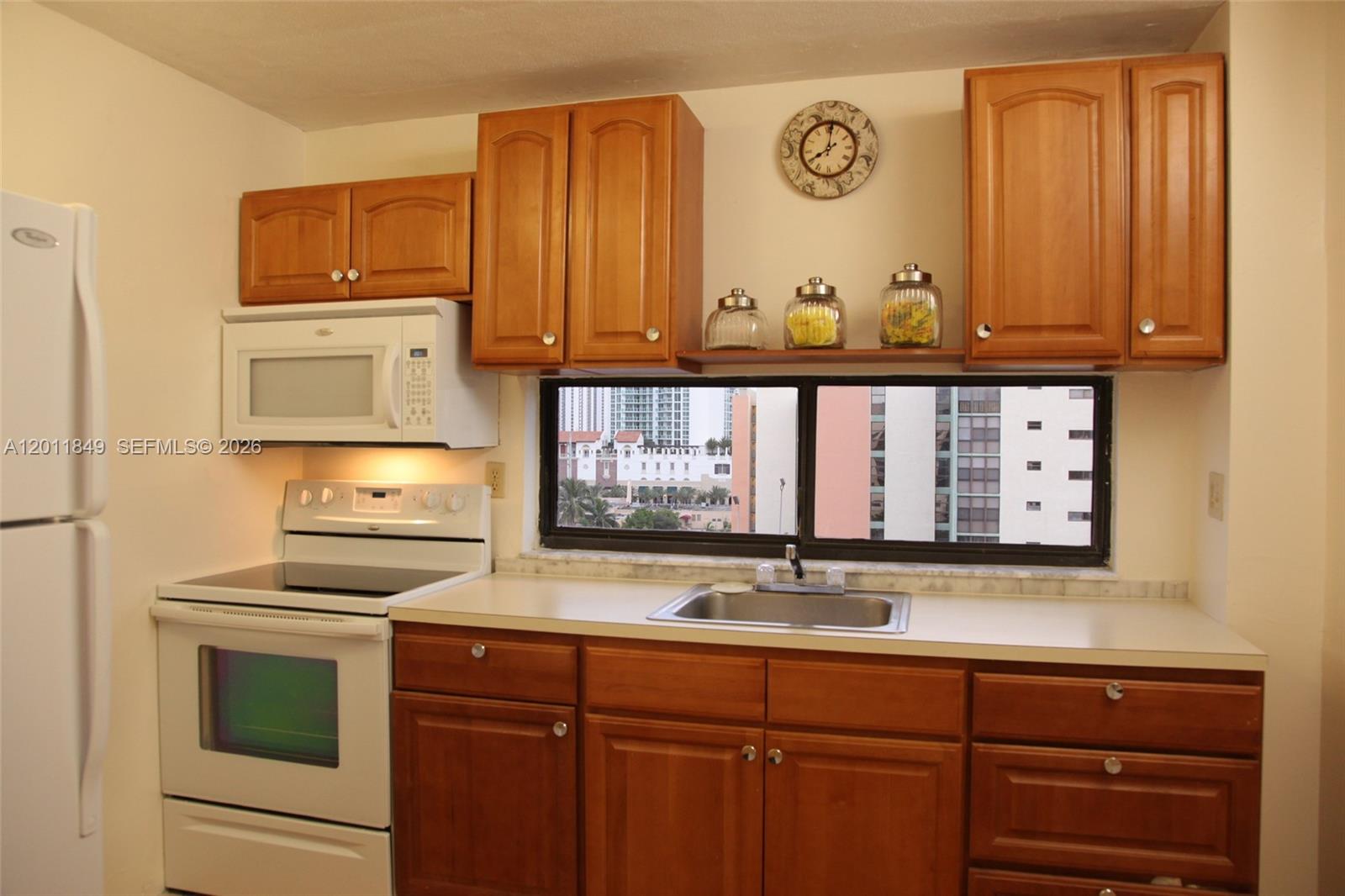 17011 North Bay Road, Unit 918 Sunny Isles Beach, FL 33160 - Photo 11 of 21 a kitchen with granite countertop stainless steel appliances a stove and a sink